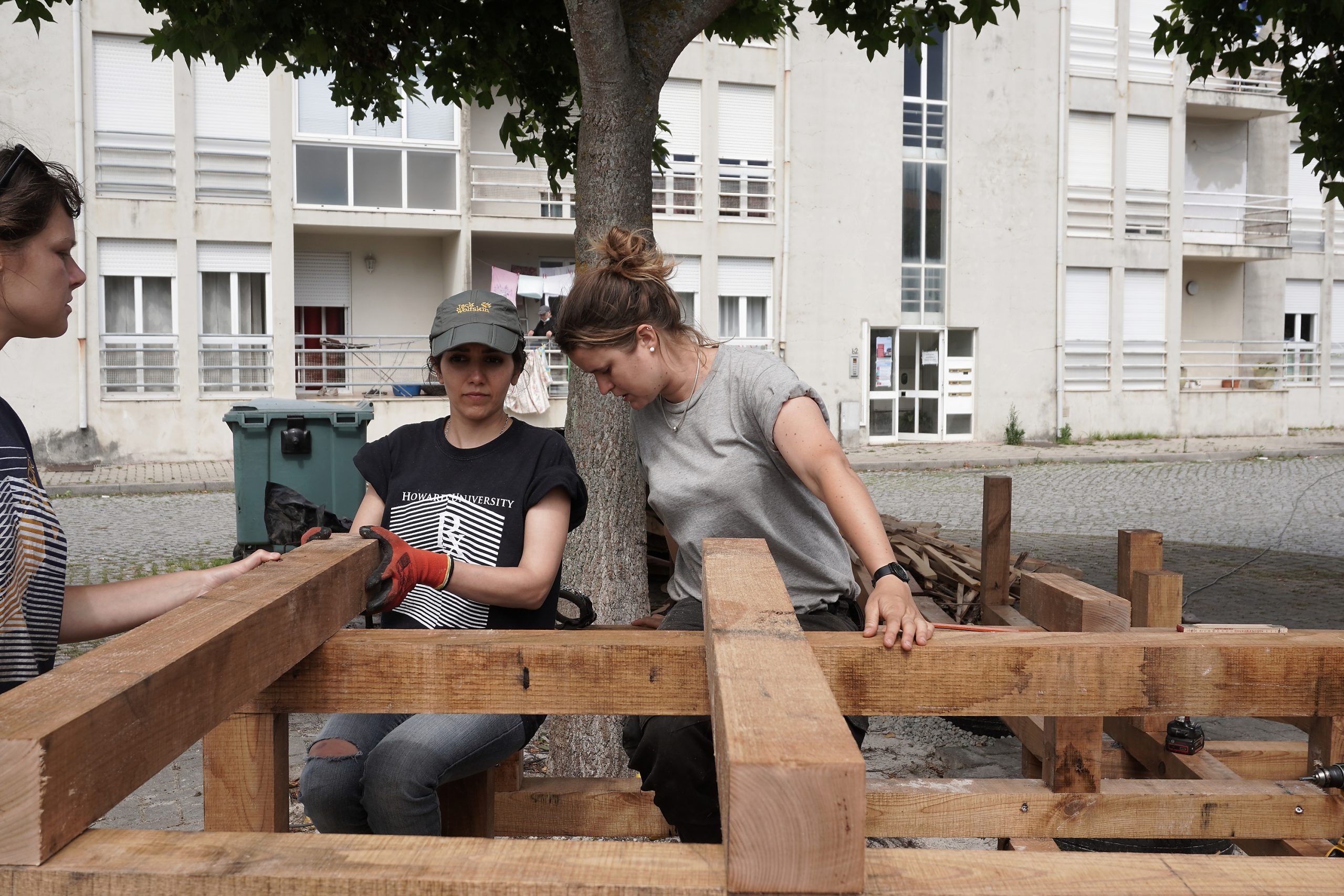 Deux participantes vissent la structure bois